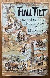 A picture of the cover of Full Tilt by Dervla Murphy. The cover is a drawing of a map with a woman on a bicycle moving through it. Pictures from India included