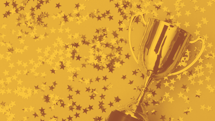 A photo of a trophy with star-shaped confetti all around it