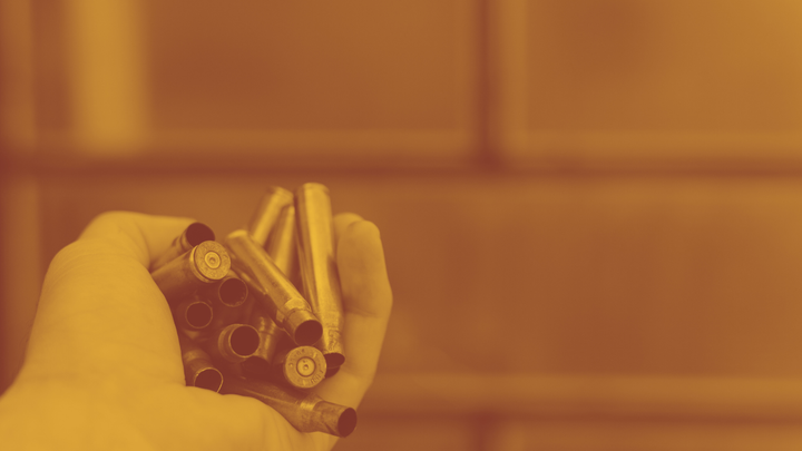 A photo of a hand holding a bunch of bullets.