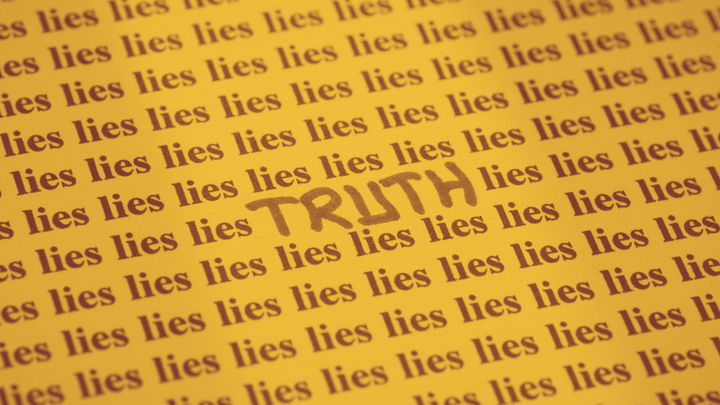 A sheet of paper with the word lies printed over and over with the word TRUTH written in the middle of the page