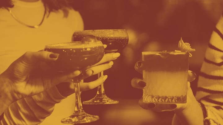 A photo of three cocktails held in women's hands - you can see nail polish and jewelry - a very 80's vibe.